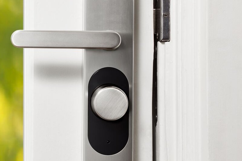 Close-up of a smart-lock handle and keyless hardware fitted to a door